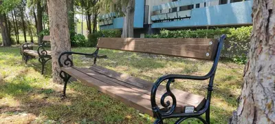 two park benches sitting next to a tree at Хостел Спортна база Ветрен in Burgas City