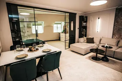 a living room with a table and a couch at The Loft - Parking - Washer&Dryer - Port view - Balcony in Burgas City