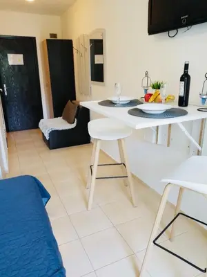 a kitchen and living room with a table and chairs at Jasmine A17 Cozy Studio Sunny Beach in Sunny Beach