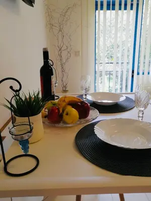 a table with a plate of fruit and a bottle of wine at Jasmine A17 Cozy Studio Sunny Beach in Sunny Beach