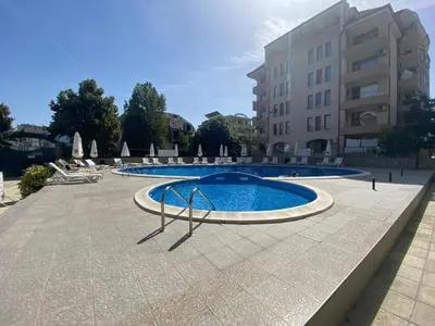 a large swimming pool in front of a building at Jasmine A17 Cozy Studio Sunny Beach in Sunny Beach