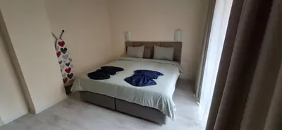 a bedroom with a bed with blue clothes on it at Star Dreams P2 in Sveti Vlas