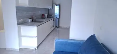 a kitchen with a blue couch and a blue chair at Star Dreams P2 in Sveti Vlas