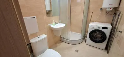 a bathroom with a toilet and a sink and a washing machine at Star Dreams P2 in Sveti Vlas