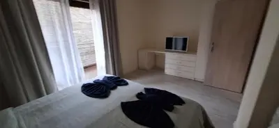 a bedroom with a bed with blue sheets and a window at Star Dreams P2 in Sveti Vlas