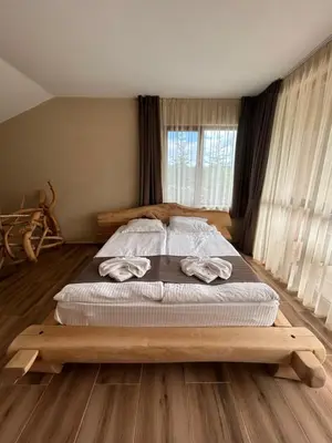 a bedroom with a bed with two towels on it at Вилно селище Зора in Shkorpilovtsi