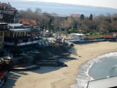 a view of a beach with buildings and the ocean at Тихия кът in Sozopol