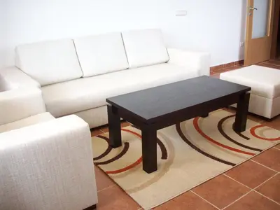 a living room with a white couch and a coffee table at Apartments Helios in Pomorie