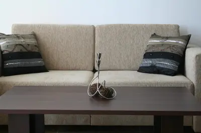 a coffee table in front of a couch at Apartments Helios in Pomorie