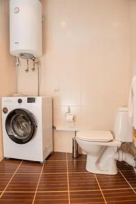 a bathroom with a washing machine and a toilet at Atlantis Resort Private 1BD apart by Flat Mаnager in Burgas City