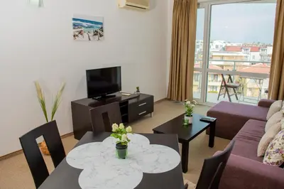 a living room with a couch and a table at Atlantis Resort Private 1BD apart by Flat Mаnager in Burgas City