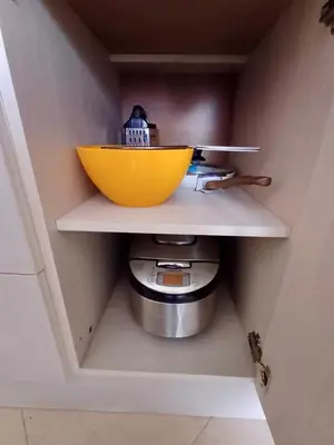 a yellow bowl on a shelf in a kitchen at La Dahlia studio - Cascadas family resort in Sunny Beach