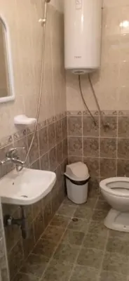 a bathroom with a sink and a toilet at Къща за гости дани in Primorsko