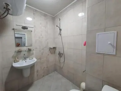a bathroom with a shower and a sink and a toilet at Neptun-Green in Primorsko