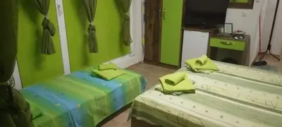 a room with two beds with lime green walls at Neptun-Green in Primorsko