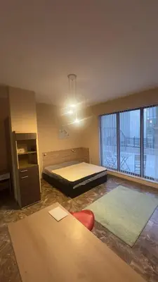 a bedroom with a bed and a large window at Studio paradise in Varna City