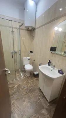 a bathroom with a toilet and a sink and a shower at Studio paradise in Varna City