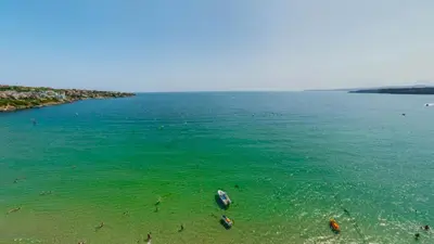 an aerial view of a beach with people in the water at Апартаменти с чадъри и шезлонги на плажа - Свети Никола Каваците in Sozopol