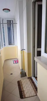a room with a hallway with a door and a tile floor at Rada's Apartment BSV in Burgas City
