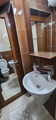 a bathroom with a sink and a toilet at Rada's Apartment BSV in Burgas City
