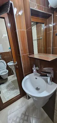 a bathroom with a sink and a toilet at Rada's Apartment BSV in Burgas City