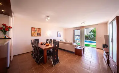 a living room with a table and a couch at Villa Belissima in Sveti Vlas