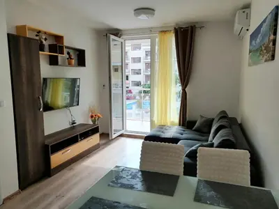 a living room with a couch and a tv at Star Beach - Звезден плаж in Primorsko