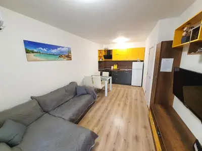 a living room with a couch and a kitchen at Star Beach - Звезден плаж in Primorsko