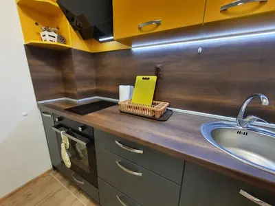 a kitchen with a sink and a yellow box on a counter at Star Beach - Звезден плаж in Primorsko