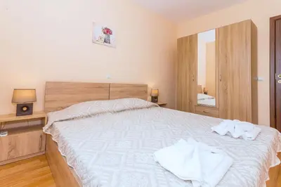 a bedroom with a bed with towels on it at Oxygen Apartments in Sveti Vlas