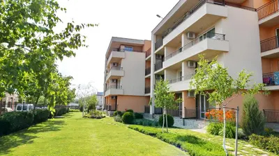 an apartment building with a lawn in front of it at Oxygen Apartments in Sveti Vlas