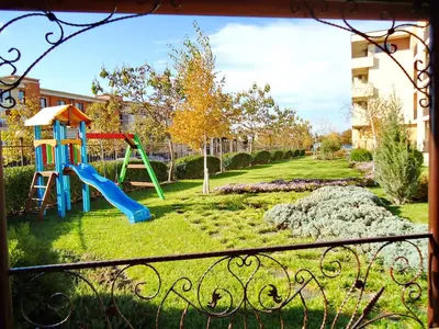 a playground with a slide in a yard at Oxygen Apartments in Sveti Vlas