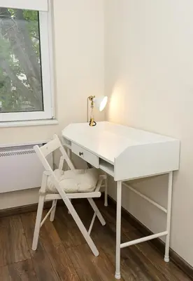 a white desk with a chair next to a window at Cozy & Functional by the Opera in Varna City