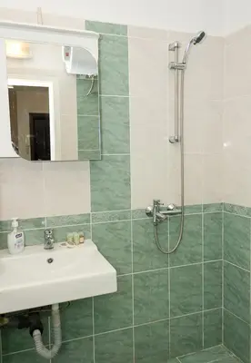 a bathroom with a sink and a shower at Cozy & Functional by the Opera in Varna City