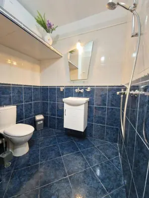 a bathroom with a toilet and a sink and a shower at Lazur Sea Garden 2 in Burgas City