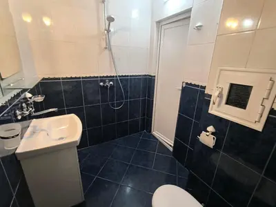 a bathroom with a sink and a toilet and a shower at Lazur Sea Garden 2 in Burgas City