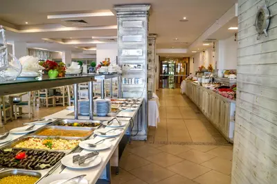 a buffet line in a restaurant with many plates of food at Hotel Oasis Del Mare in Lozenets