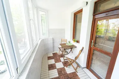 a balcony with a table and chairs and a window at Soleado in Burgas City