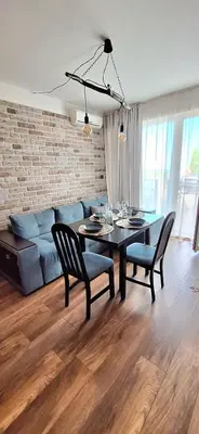 a living room with a table and a couch at Студио Бяла in Byala