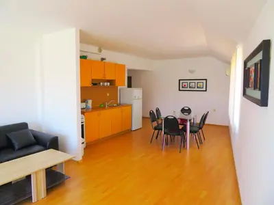 a kitchen and dining room with a table and chairs at Апартамент Съни Хаус - Sunny House Apartment in Byala