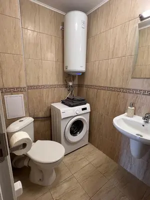 a bathroom with a toilet a sink and a washing machine at Vineyard Spa Resort Aheloy - Muscat-6 Studio in Kableshkovo