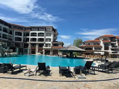 a swimming pool with lounge chairs in front of a building at Vineyard Spa Resort Aheloy - Muscat-6 Studio in Kableshkovo