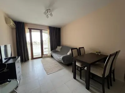 a living room with a table and a couch at Sea Side Apartment with Balcony in Sveti Vlas
