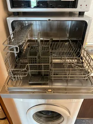 a dishwasher with a drying rack on top of it at Sea Side Apartment with Balcony in Sveti Vlas