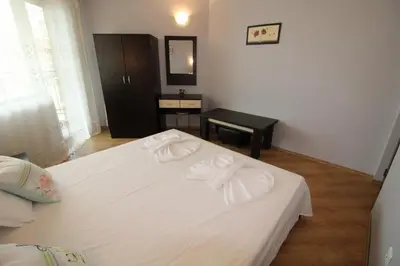 a bedroom with a white bed with two towels on it at Amadeus 5 - Menada Apartments in Sunny Beach