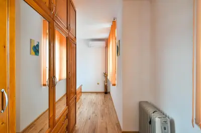 a hallway with a wooden door and a radiator at Roman Thermae, steps from the sea with free parking in Varna City
