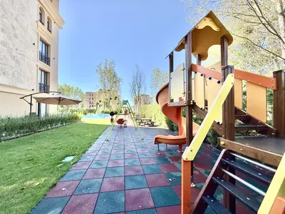 a playground with a slide in a park at Menada Aphrodite Green Apartments in Sunny Beach