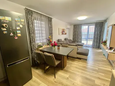 a living room with a table and a couch at Sea Sunrise Apartment in Burgas City