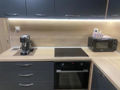 a kitchen with a stove and a microwave on a counter at Sea Sunrise Apartment in Burgas City
