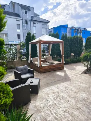 a patio with a gazebo and a couch and chairs at Excellent apartment on the 6th floor in Sunny Beach